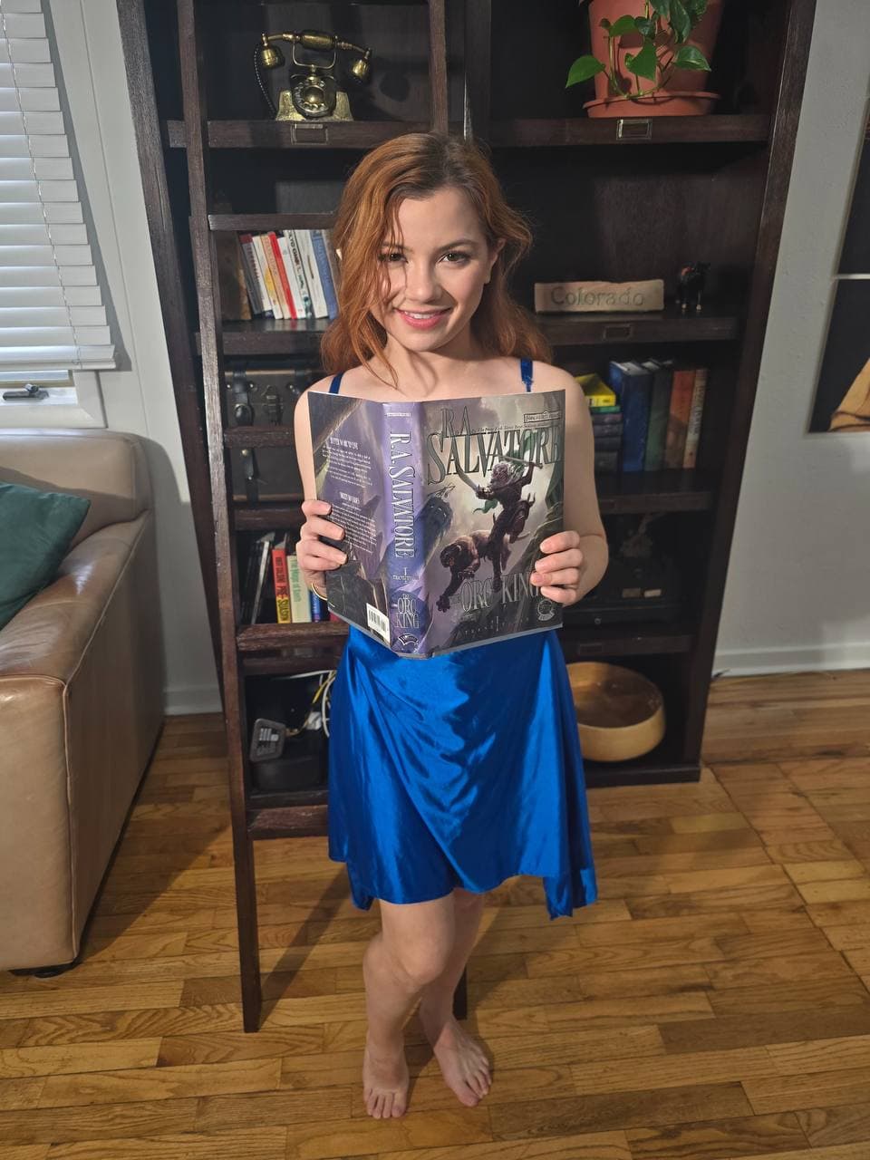 Alice Little holding a fantasy novel